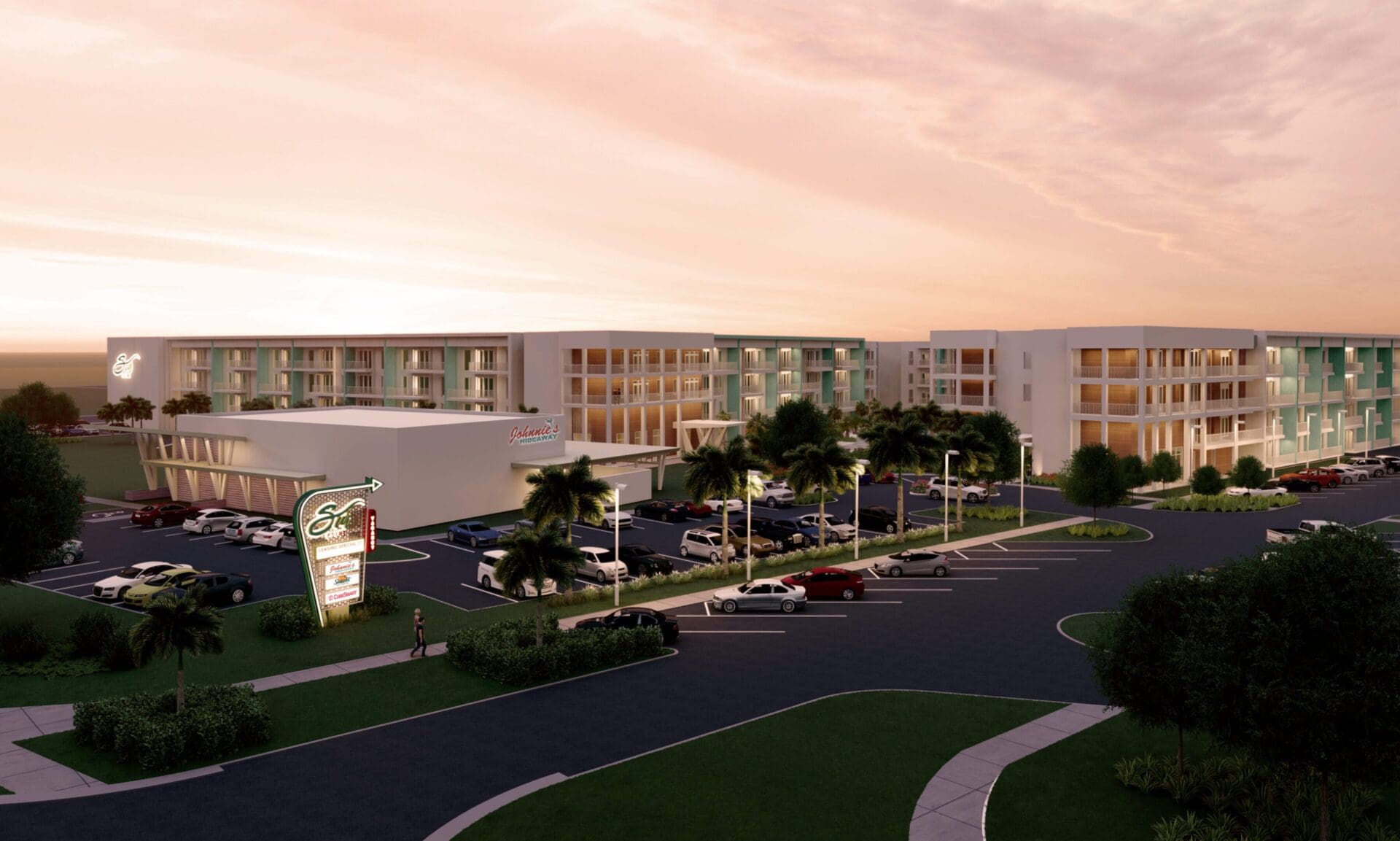 Modern hotel building at sunset with parking.