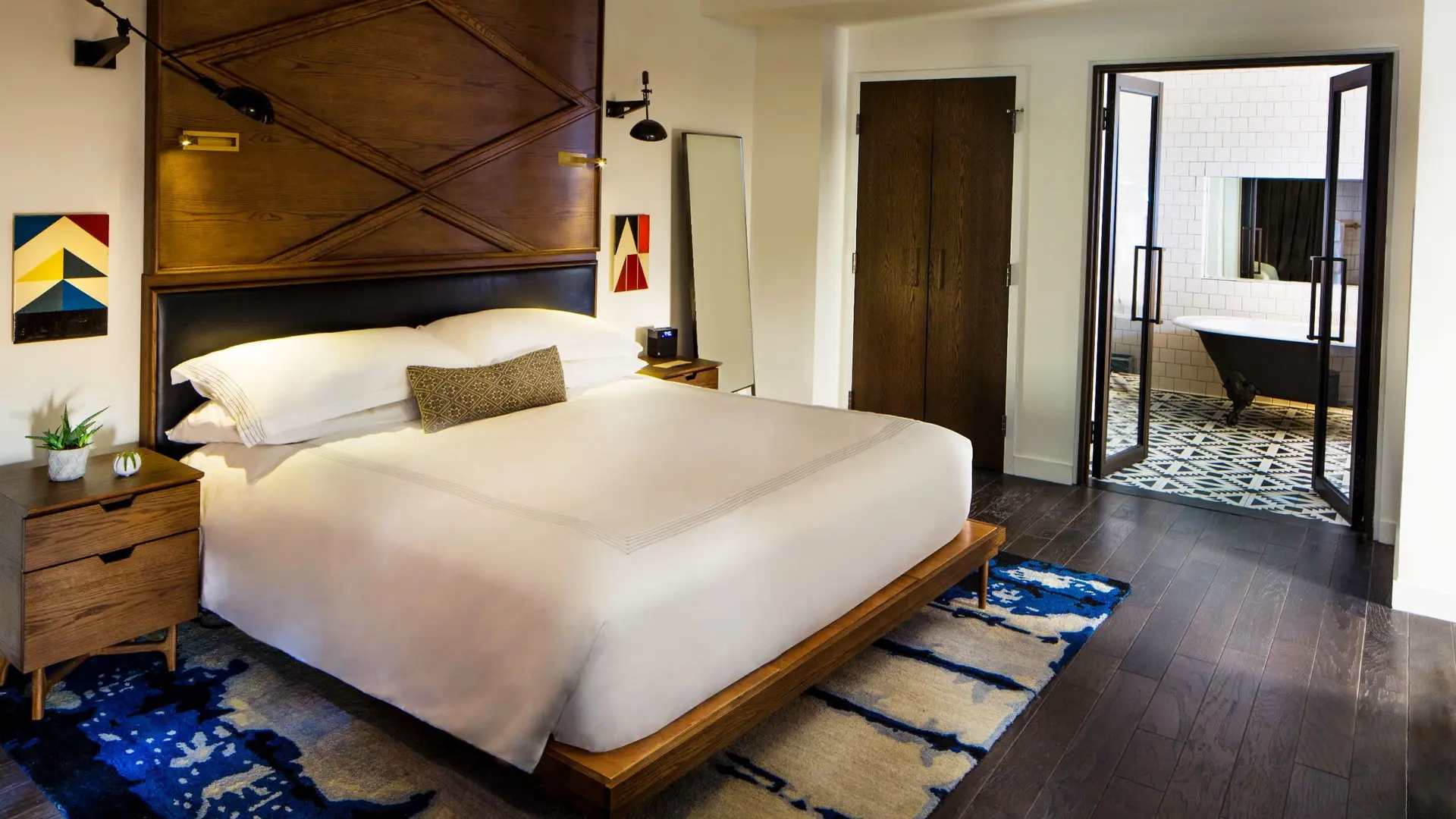 Modern bedroom with wooden accents and bathroom.