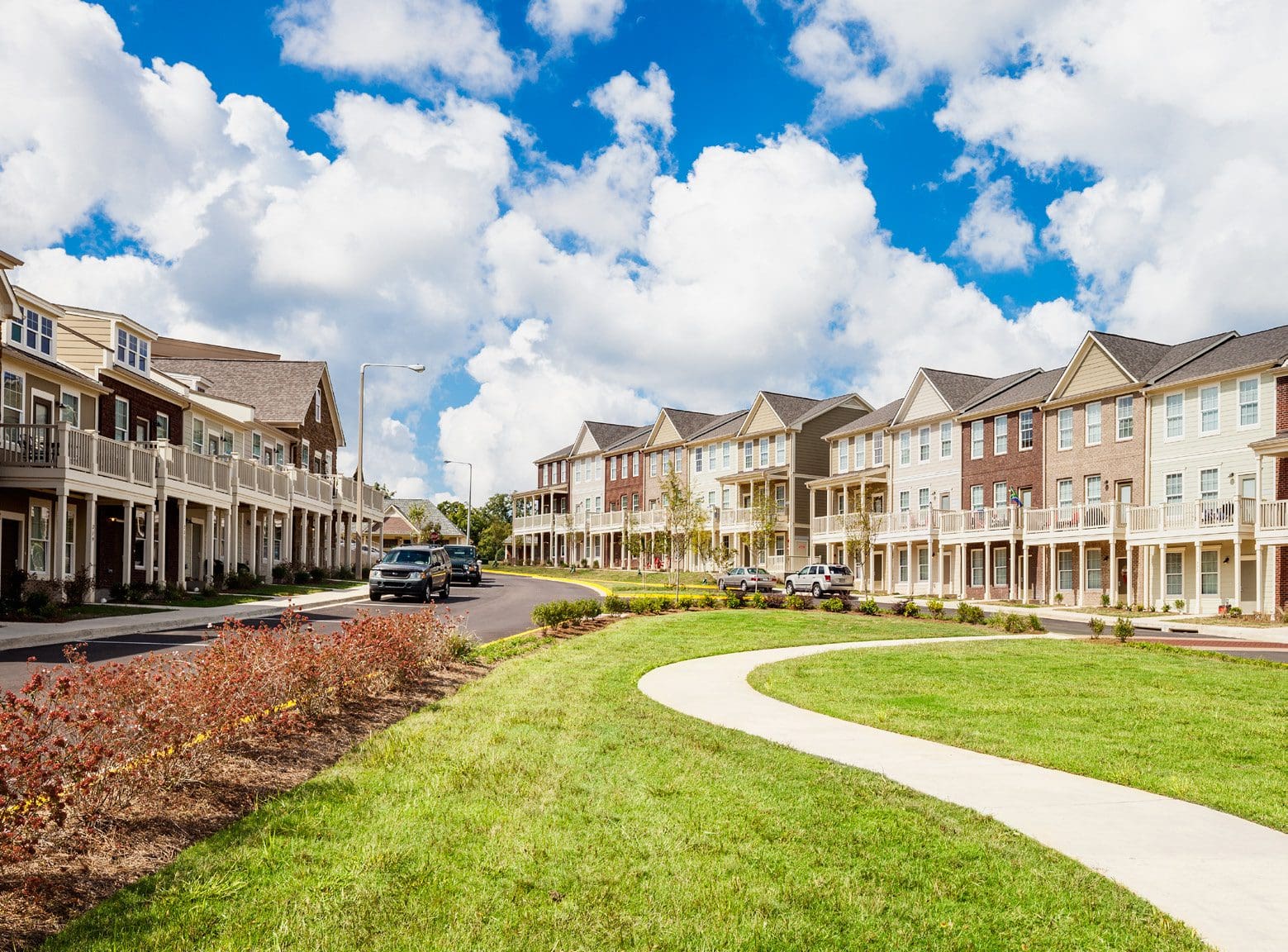 Suburban neighborhood street with row houses.