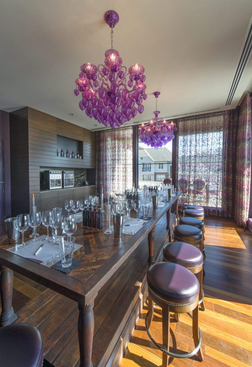 Elegant dining room with purple chandeliers.