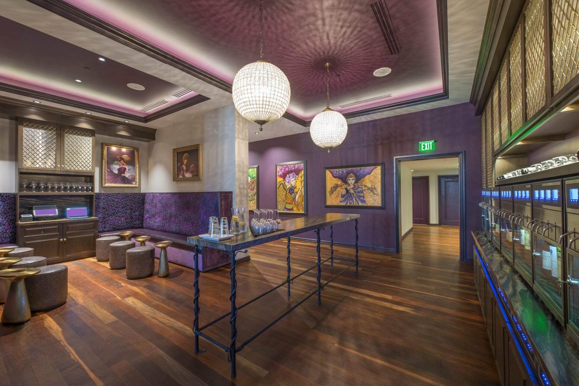 Luxurious room with chandeliers and purple decor.