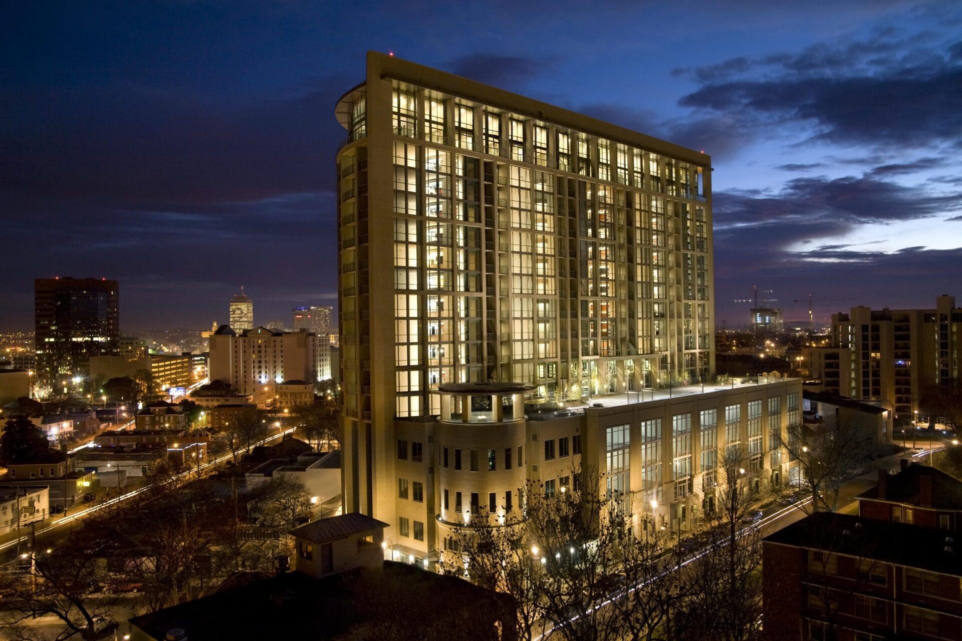 Illuminated building against a nighttime cityscape.