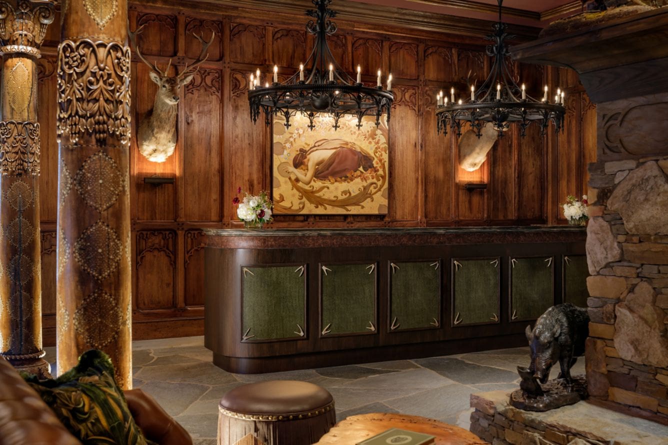Rustic hotel lobby with chandeliers and artwork.