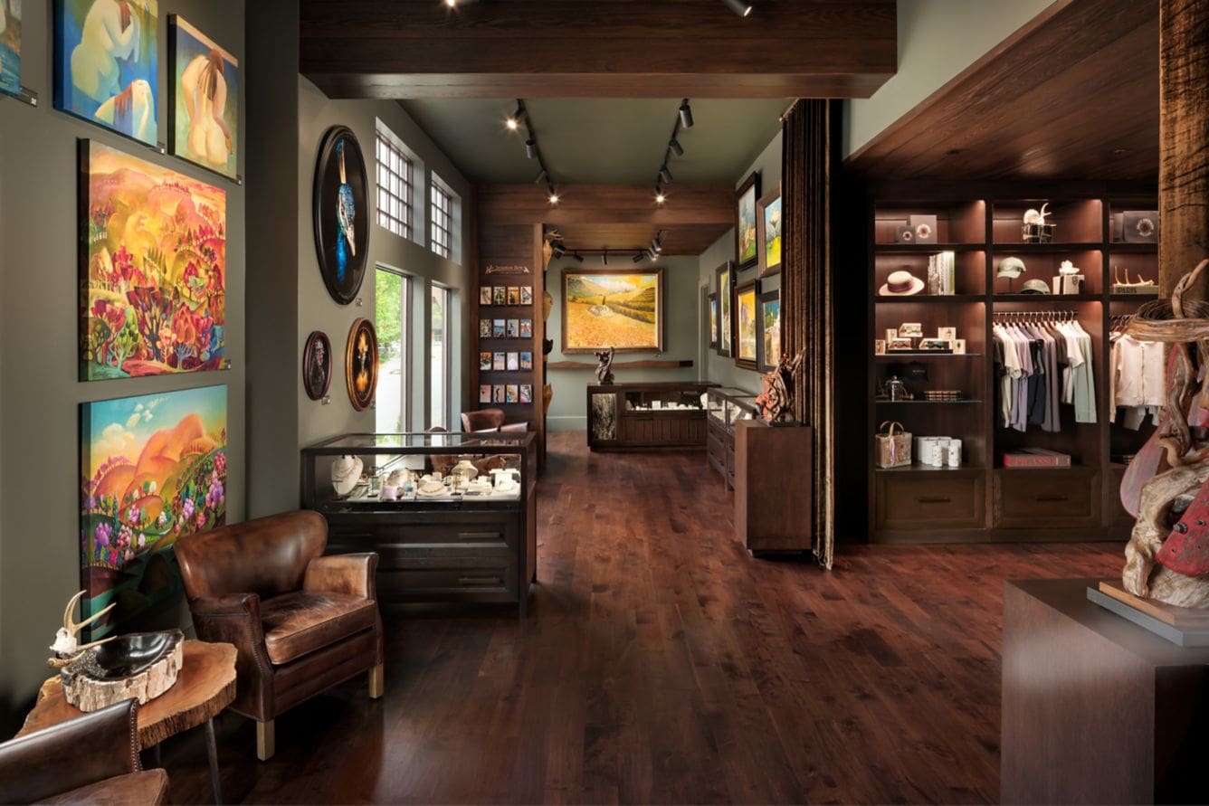 Art gallery with paintings and wooden floors.