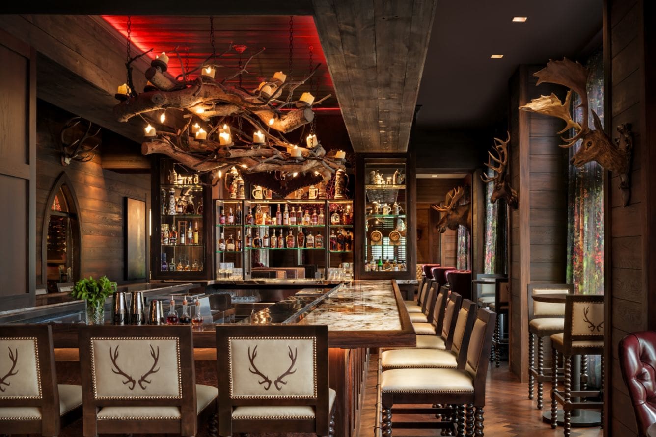Rustic bar with antler-themed decor and seating.