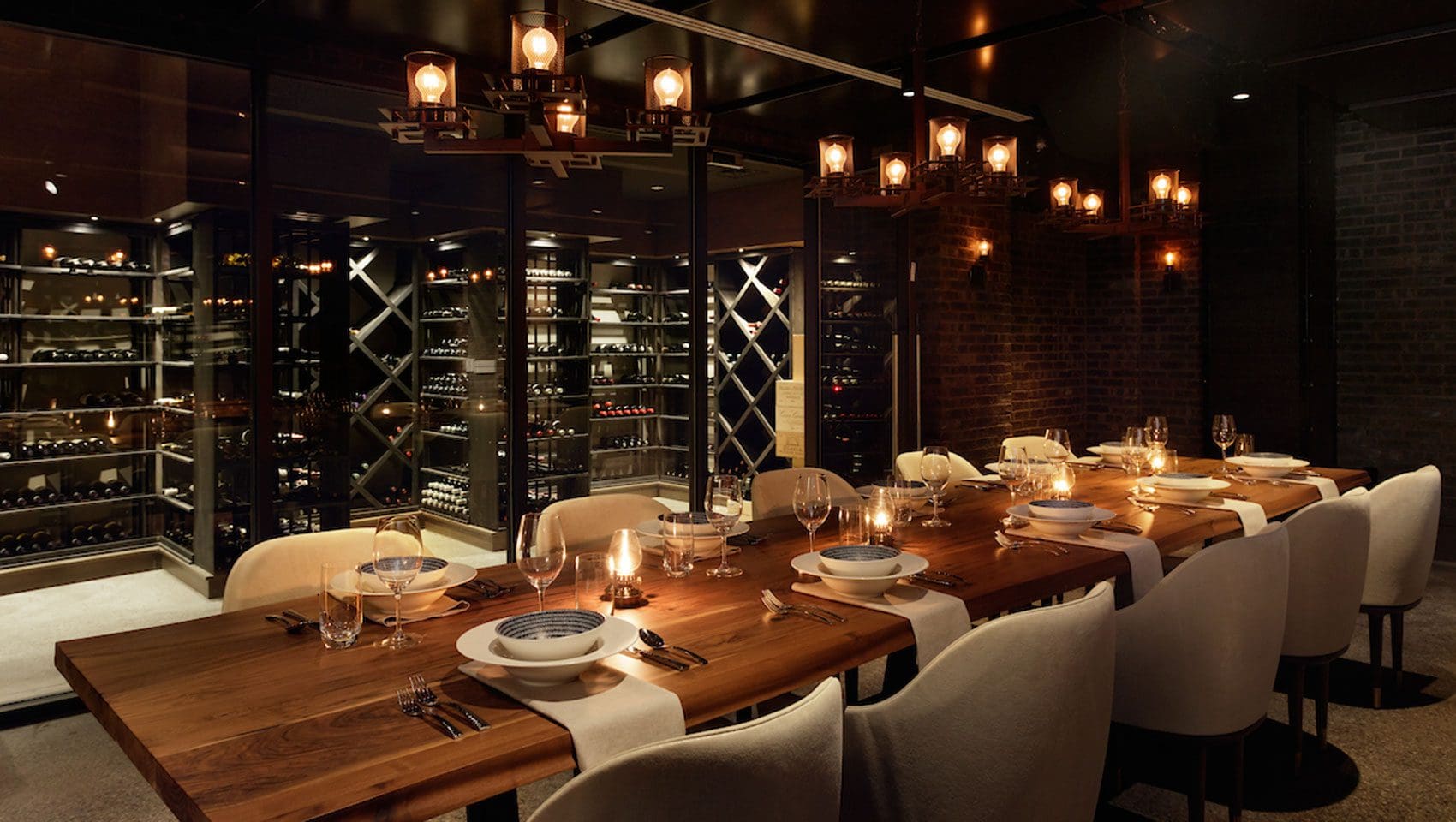 Elegant dining table with wine cellar background.