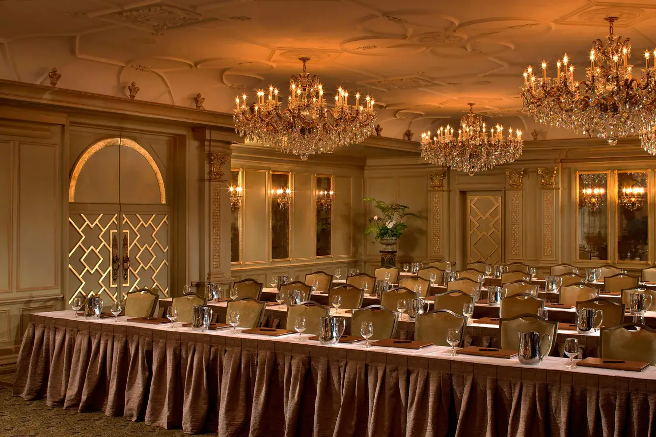 Elegant conference room with chandeliers and tables.