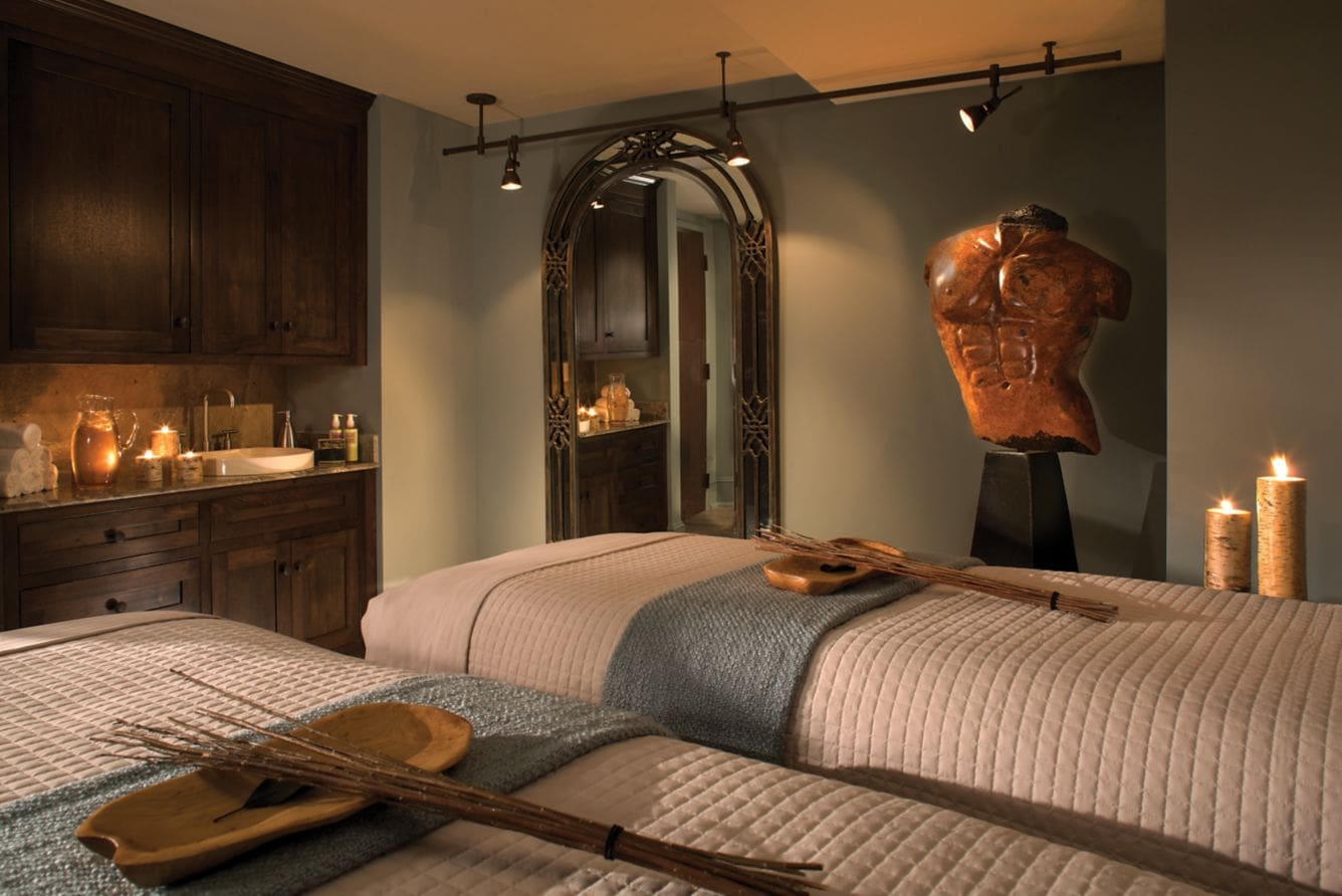 Luxurious spa room with massage tables.