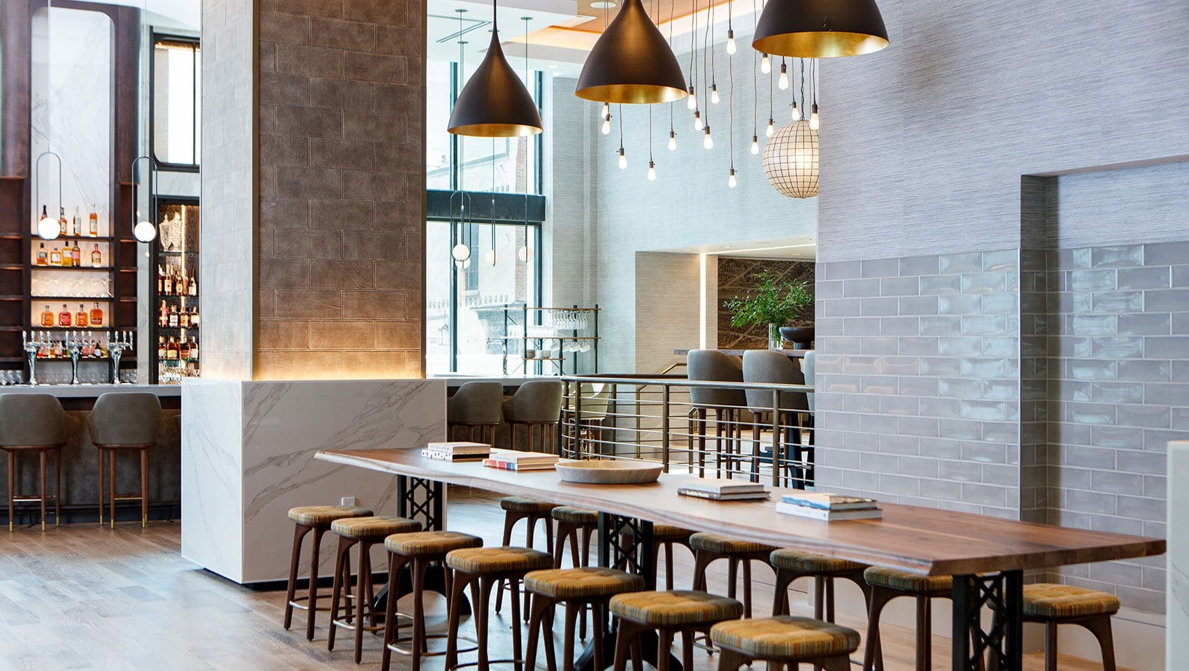 Modern bar interior with tables and stools.