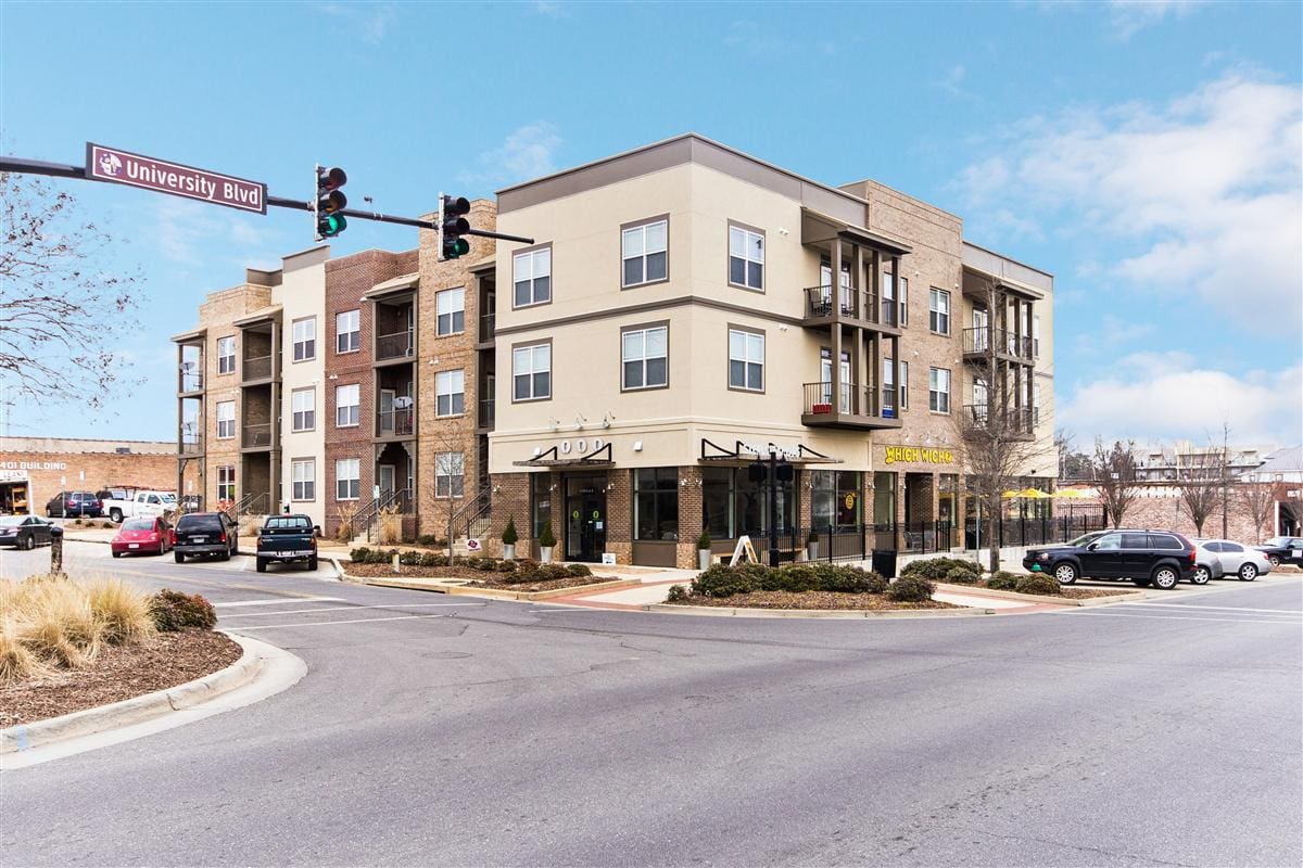 Street corner with modern apartment building.