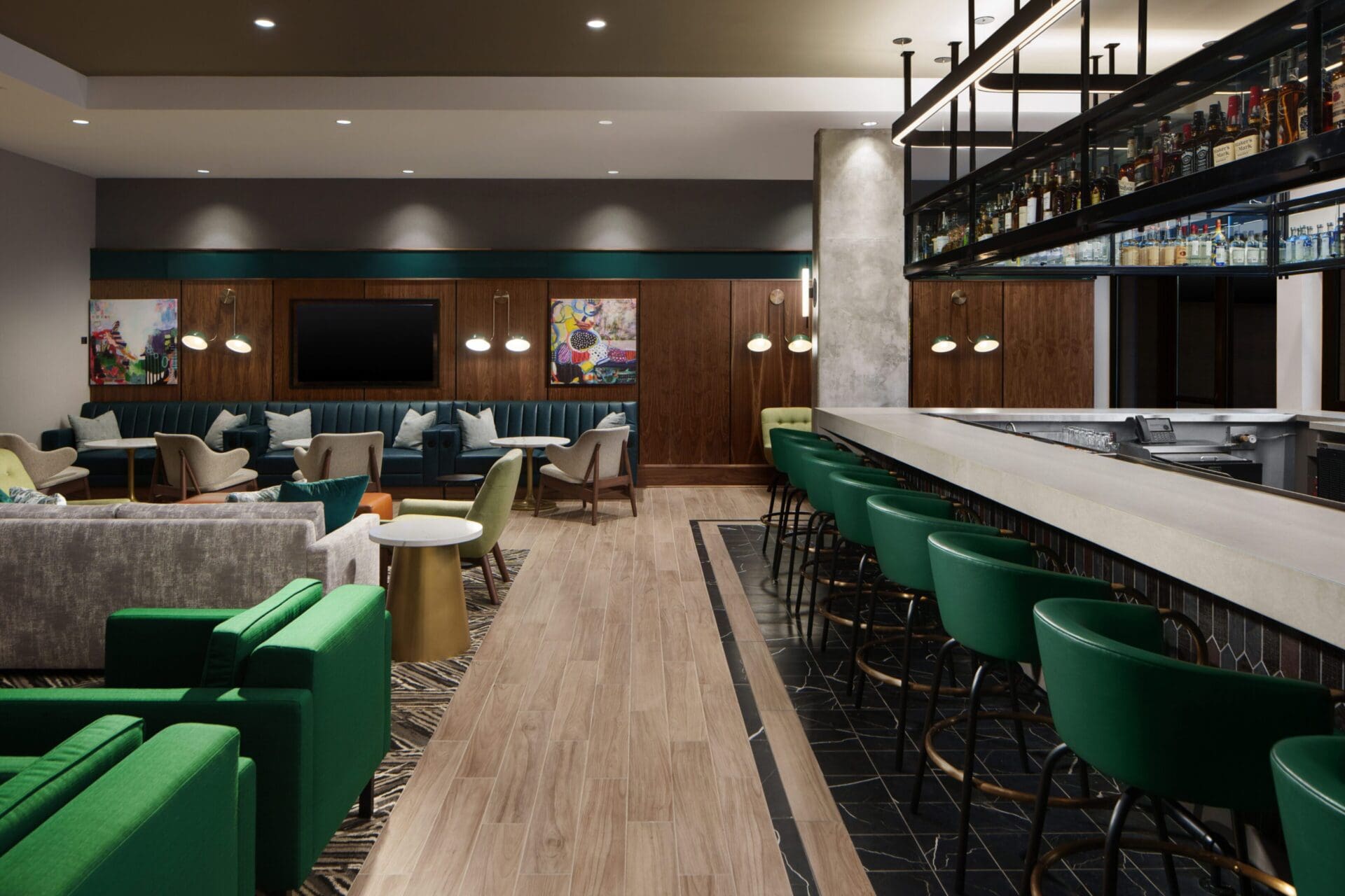 Modern lounge with bar and green seating.