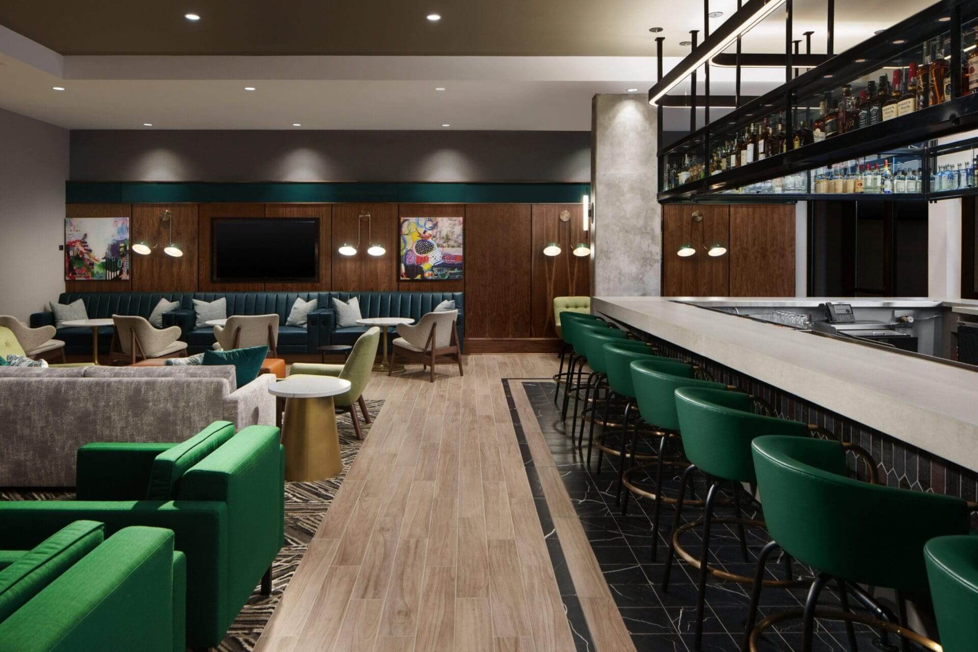 Stylish lounge bar with green seating.