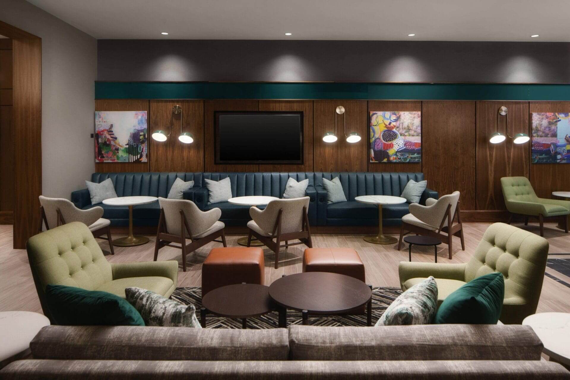 Modern lounge with seating and wall art.