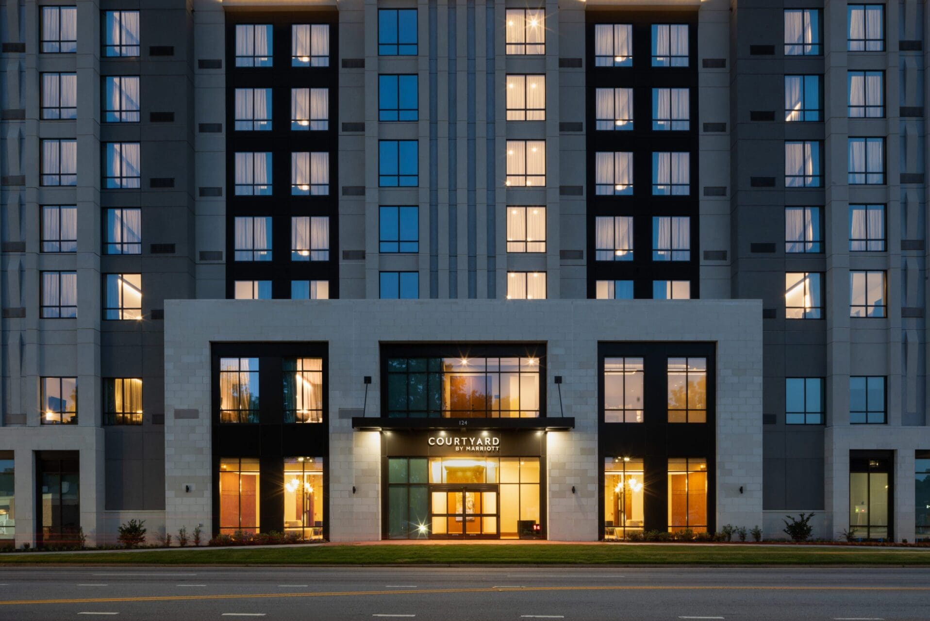 Modern hotel building illuminated at night.
