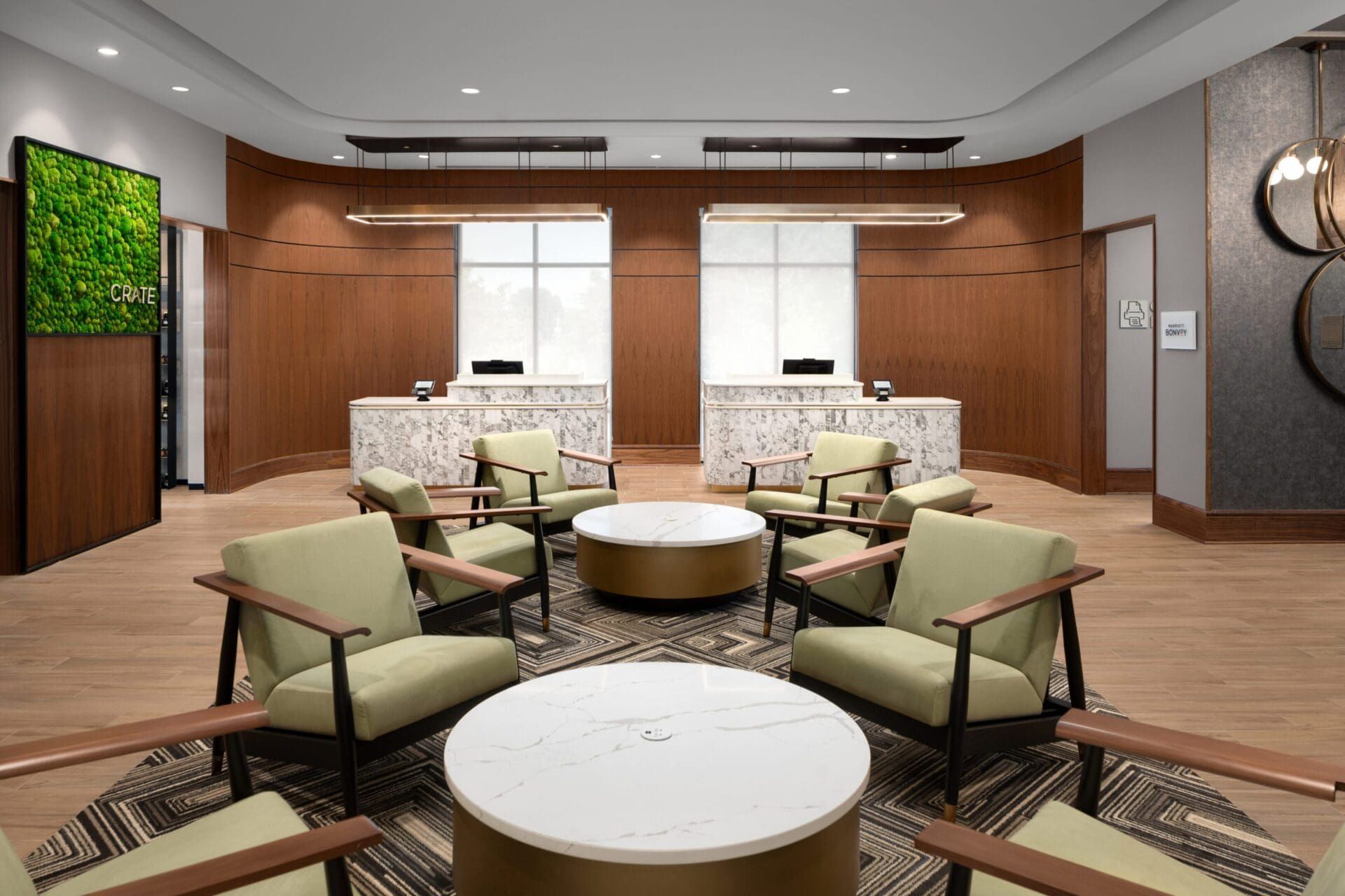 Modern office lobby with seating and desks.