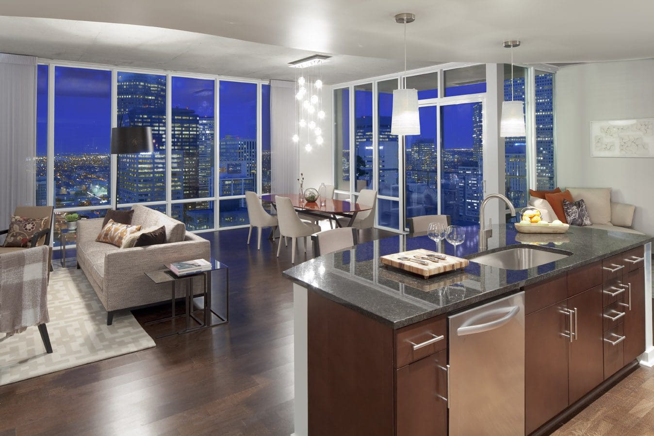 Modern apartment interior with city skyline view.