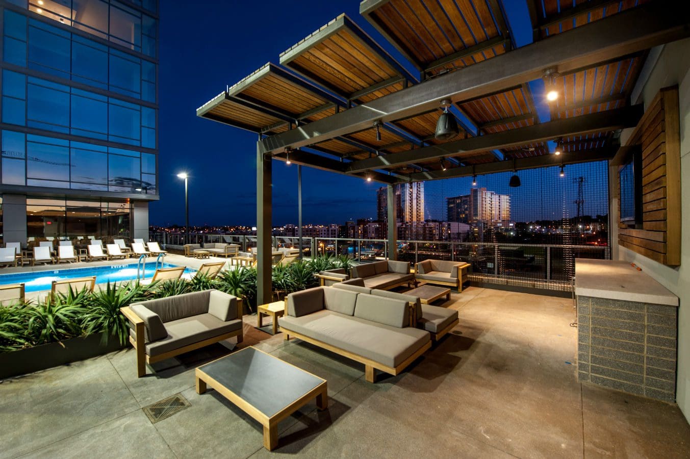 Rooftop patio with seating and city view.