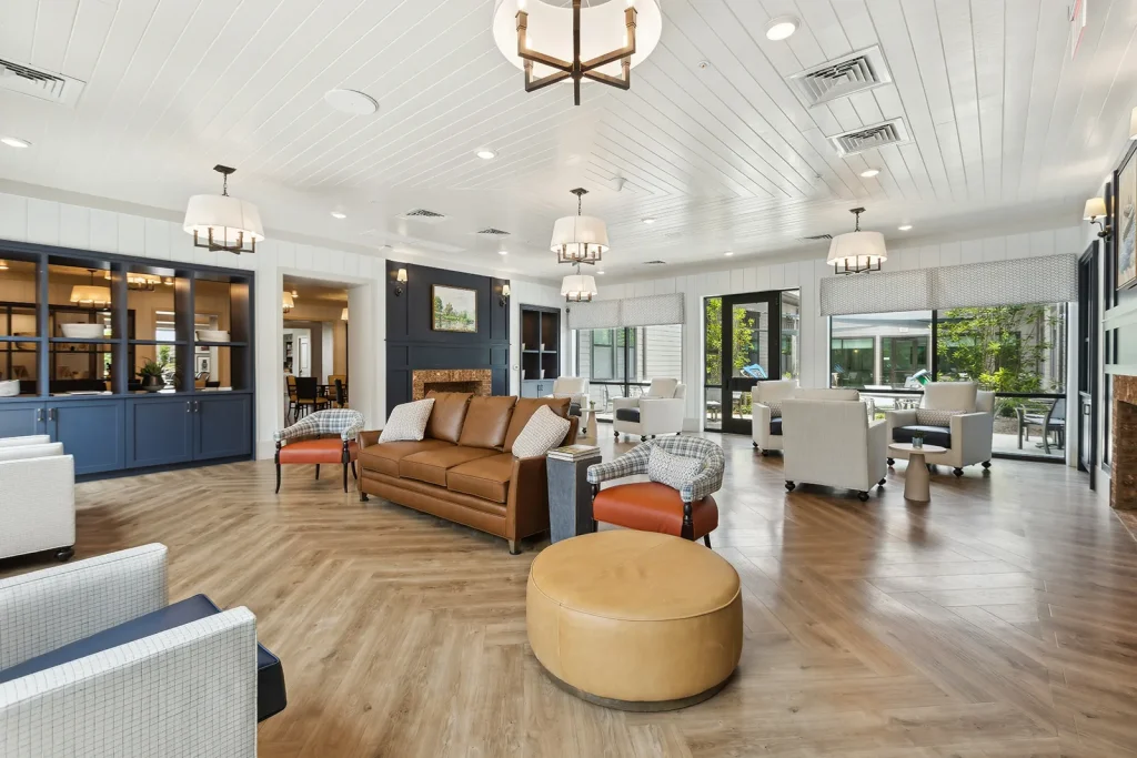 Modern kitchen with a large island and brown leather stools.