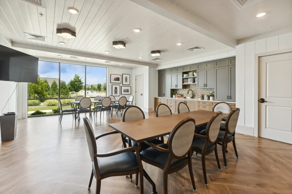 Green-paneled dining room with floral curtains