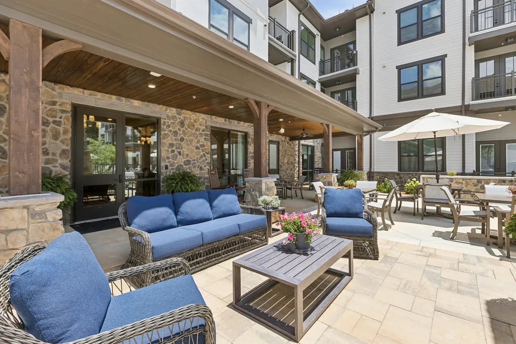 Modern kitchen with a large island and multiple chairs.