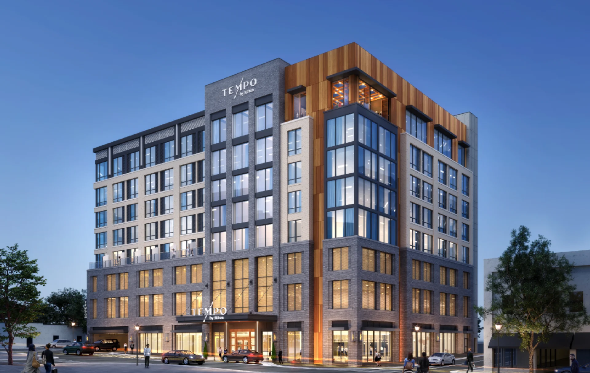 Modern multi-story building with glass windows and warm lighting.