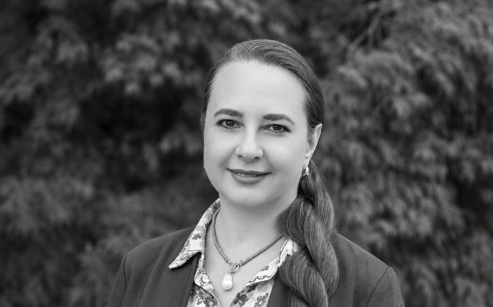 Monochrome portrait of smiling woman with braided hair