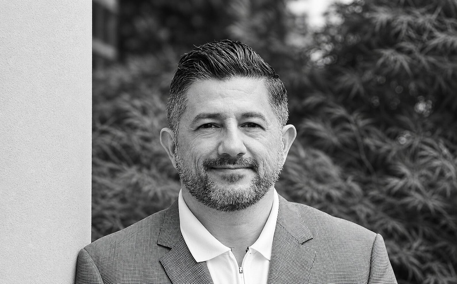 Smiling bearded man in suit jacket